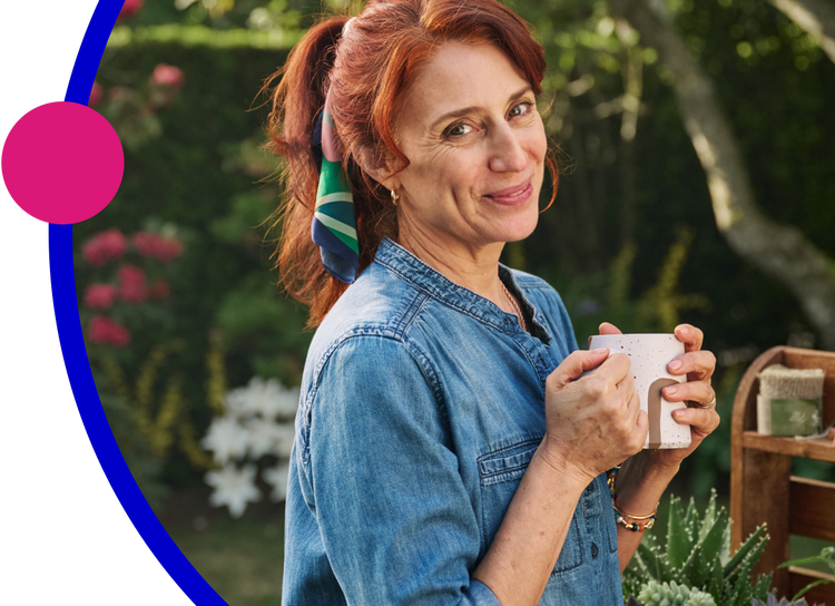 Woman outside holding a mug